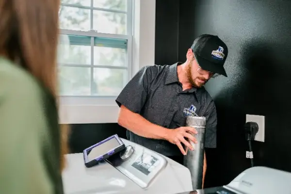 Dryer Vent Wizard professional repairing a residential dryer vent