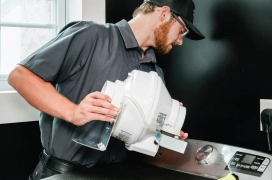 Dryer Vent Wizard professional making repair on dryer duct line.